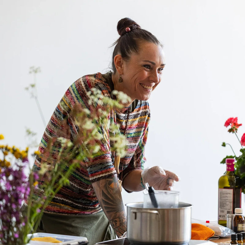 A woman preparing food during an outdoor Ecosh event.